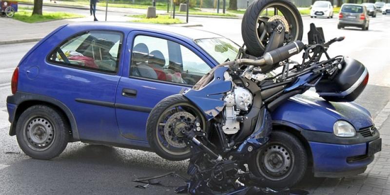 Moto accidentada sobre un coche de color azul