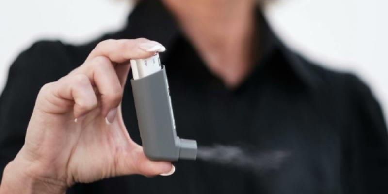 Mano de una mujer sujetando un ventolin