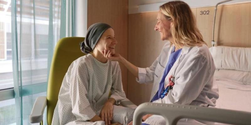 mujer agarrándole la mano a una paciente