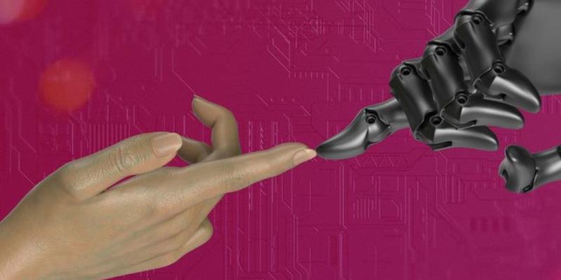 Una mano de una persona acerca su dedo a la mano de un robot