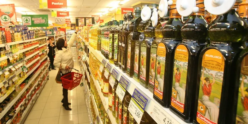 Señora comprando aceite en un supermercado