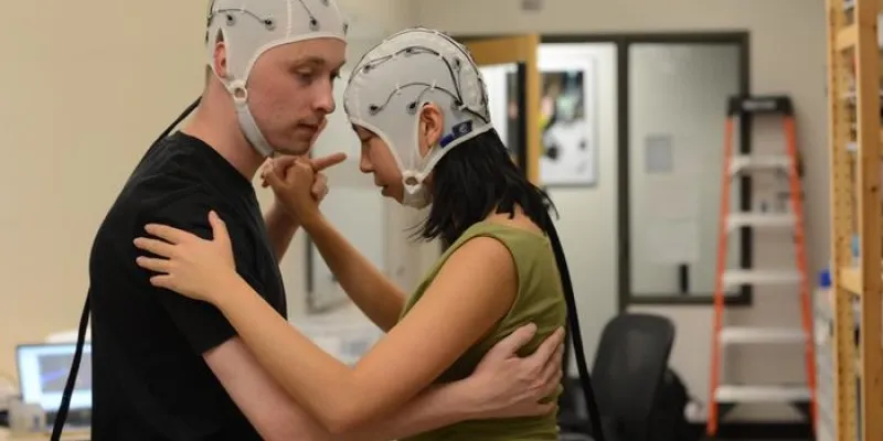 Dos bailarines de tango con gorros de electroencefalograma 