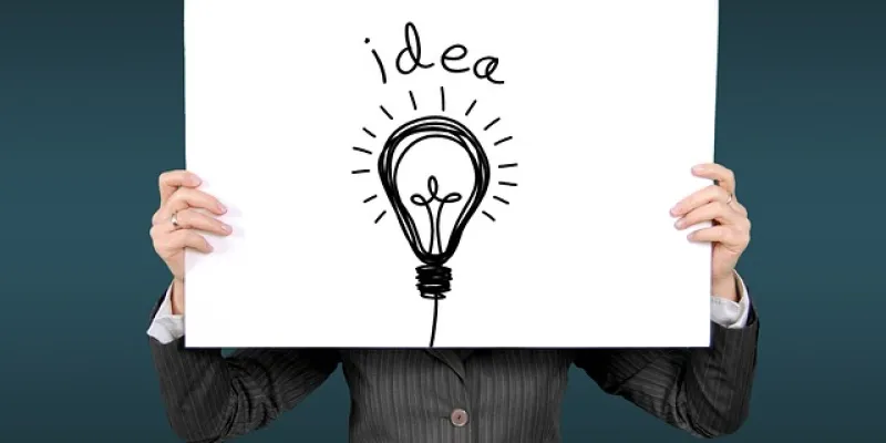 Persona sujetando un cartel en el que puede leerse "idea"