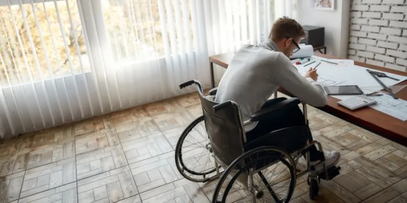 Una persona con discapacidad frente a un escritorio 
