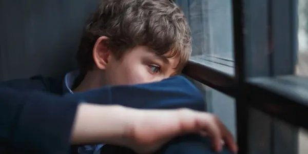 Niño mirando por una ventana