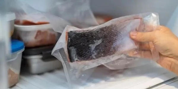 Un filete de salmón en un envase de plástico. 