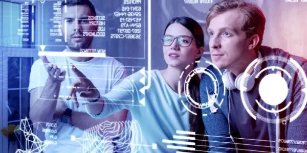 Varios jóvenes examinan datos en una pantalla panorámica 