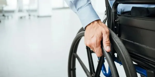 Mano de una persona en silla de ruedas